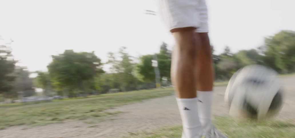 Boy practices dribbling soccer ball