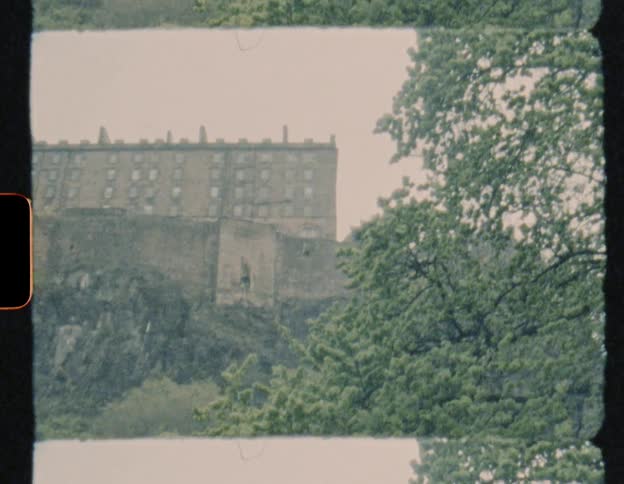 Trees grow near a large stone building