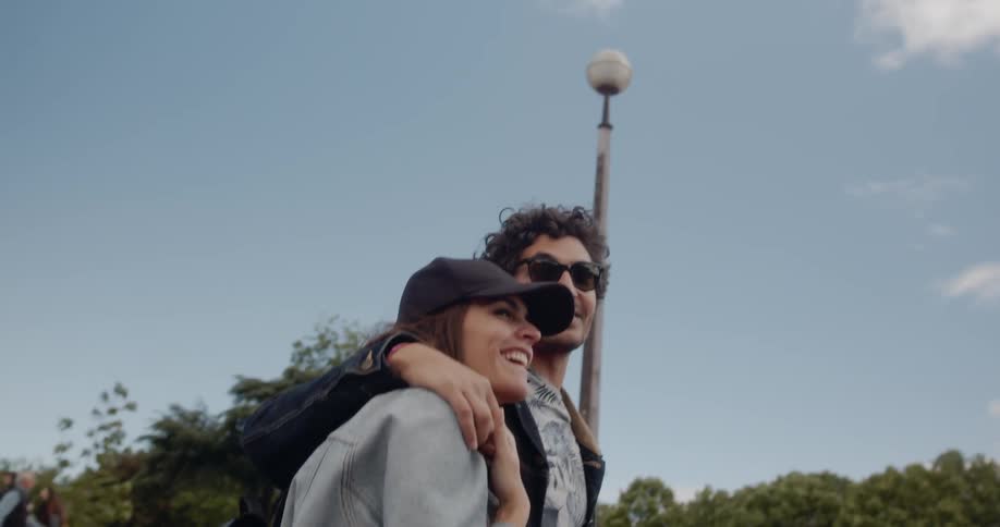 A ethnic woman smiles with her boyfriend while walking