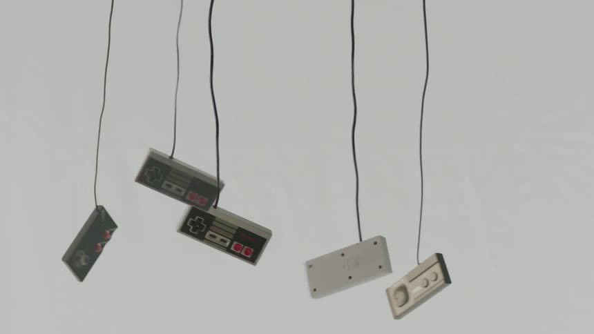 90s Video game controllers hang by their cords