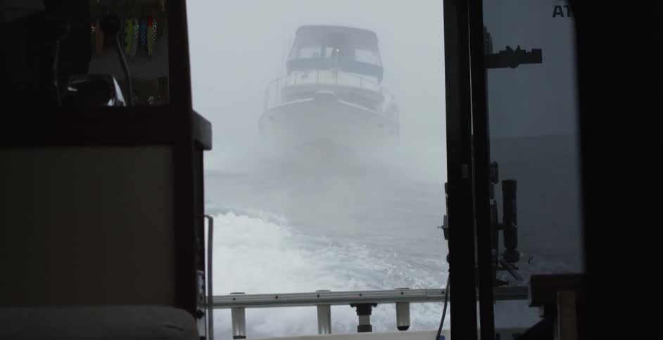 Boat follows another boat through the ocean