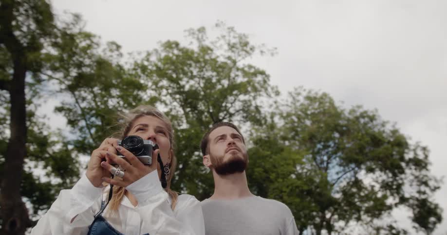 A man and woman photograph a building