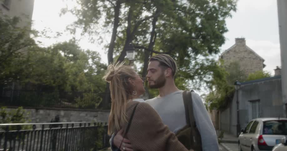 A carefree couple dances in the street in europe