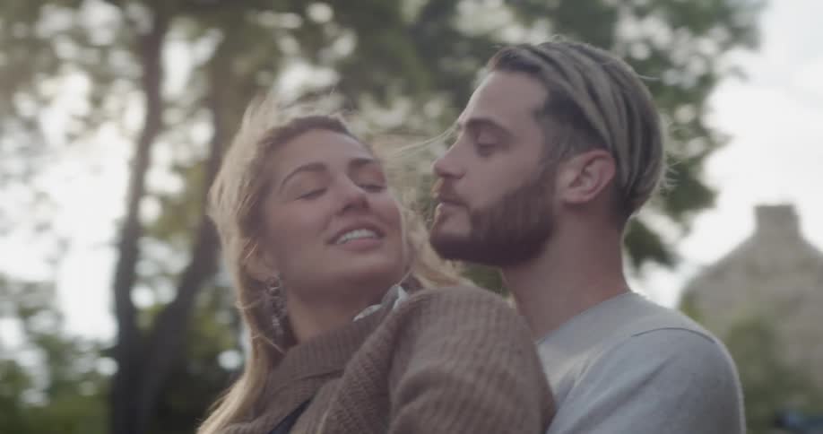 A man and woman hug outside