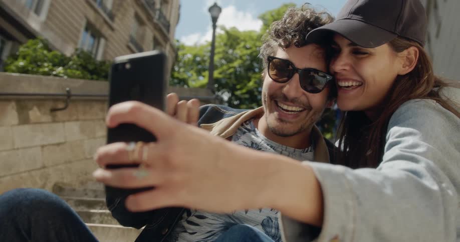 A man and woman pose for a selfie