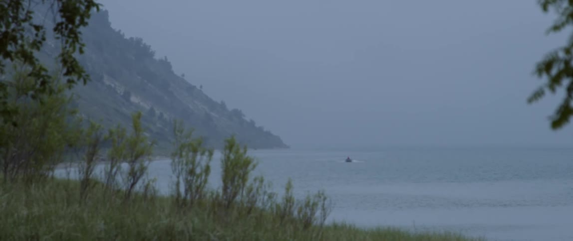 Boat travels in ocean near shore