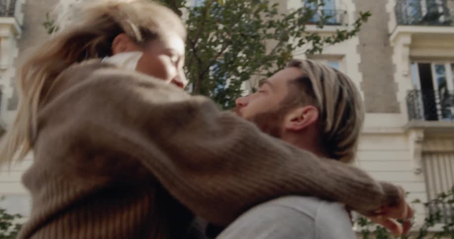 Woman runs and jumps into the arms of a man