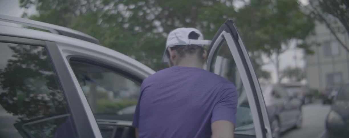 Man enters passenger side of car