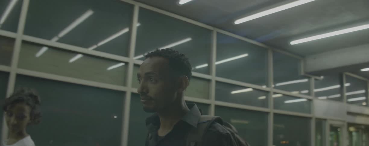 Man walks near the windows of a building