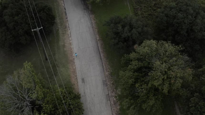 Man is jogging down an old country road