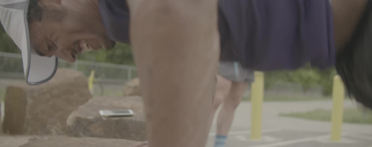Man exercises in a parking lot