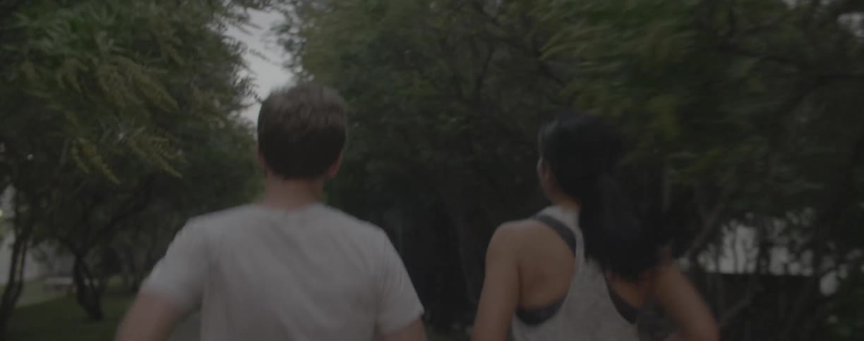 A man and woman jog together