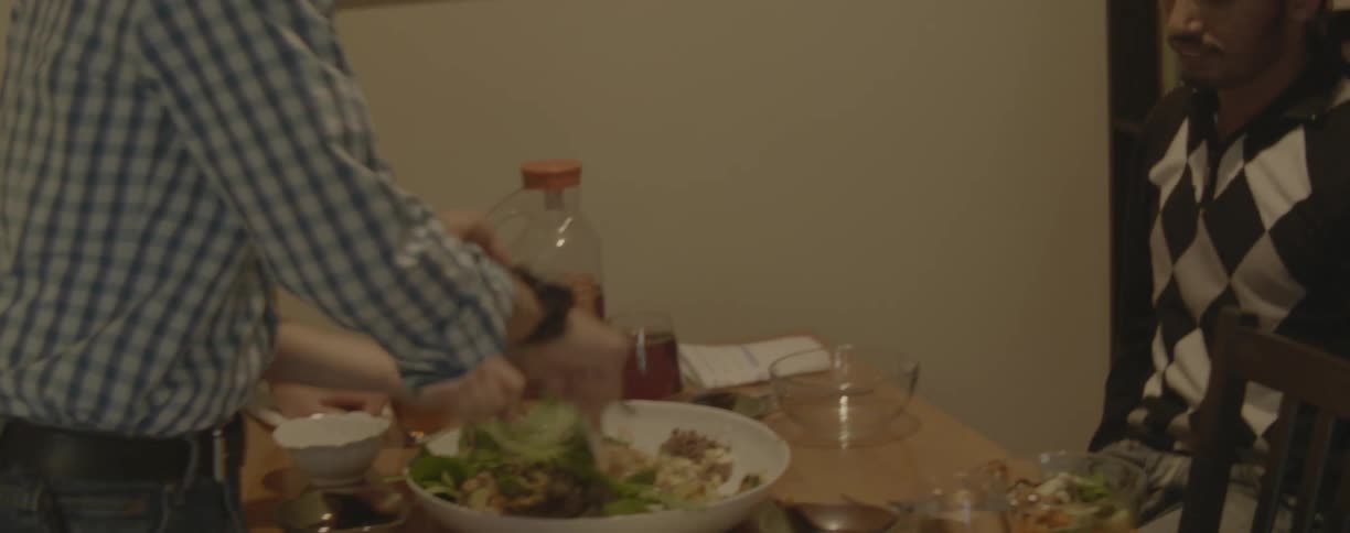 Friends sit down to eat dinner