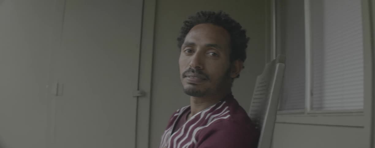 Gazing man sits in chair
