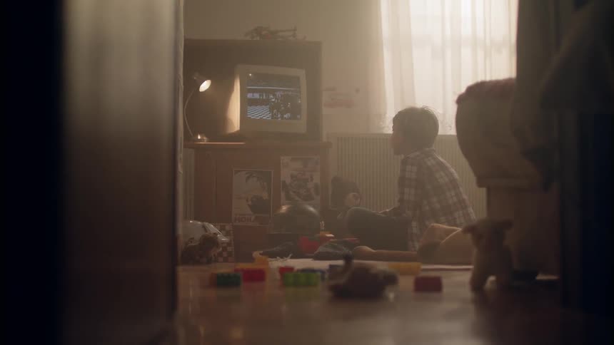 Young boy sits on the floor as he watches television