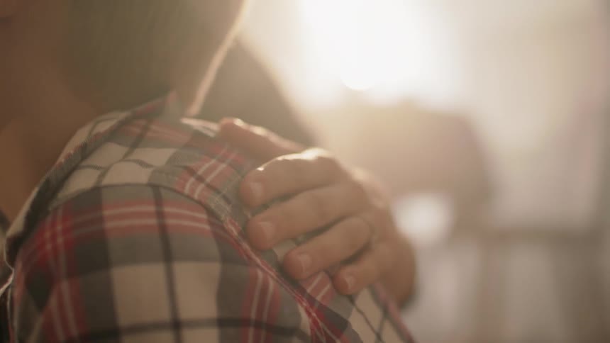 A woman rubs a boy's hair