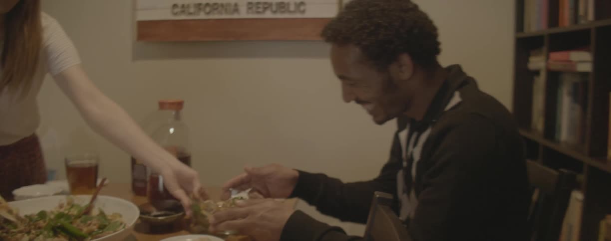 A woman serves a bowl of food to her guest