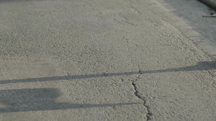 Shadow on road of person running