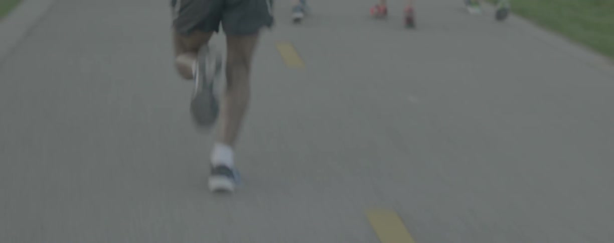 Joggers run on a paved road