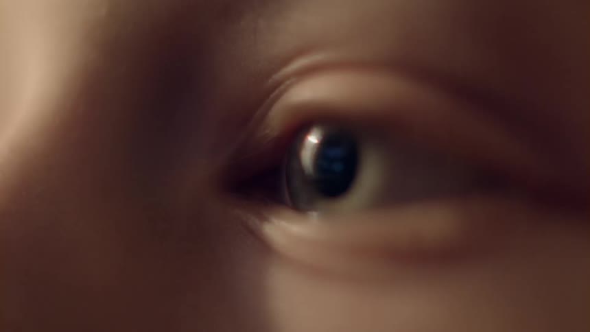 A boy blinks and looks around