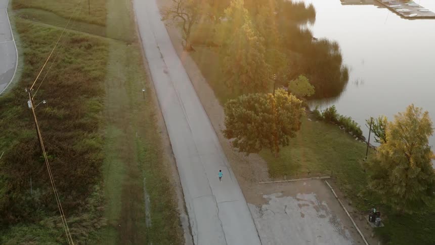 Person is running down an old country road