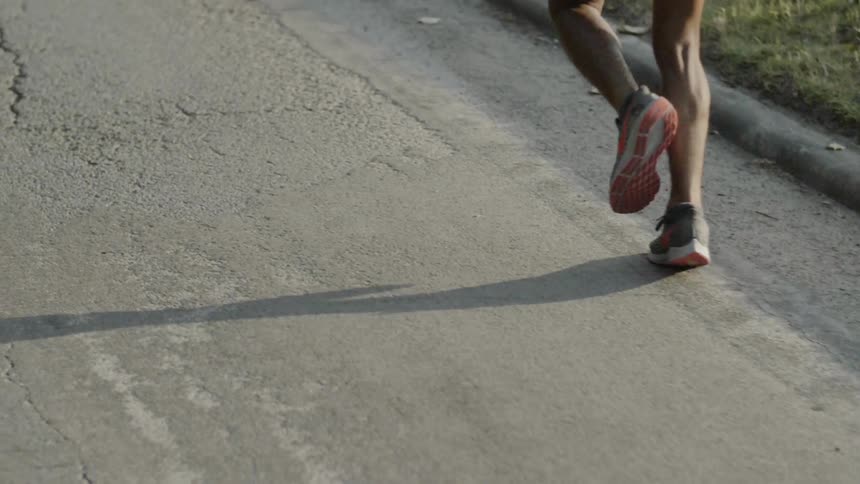 A man runs on the asphalt