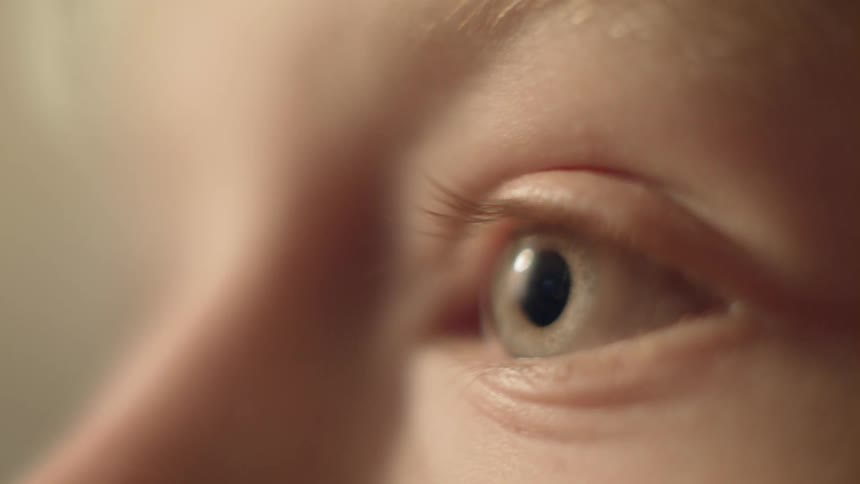 An eye stares straight ahead and blinks