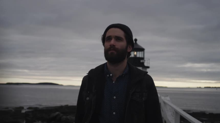 A man walks away from a lighthouse