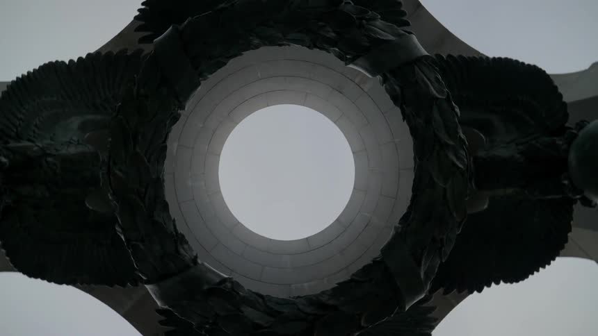 Looking up at the sky through the center of a ring tower