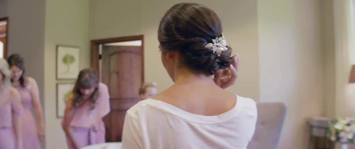 A bride gets ready for her wedding in a dressing room