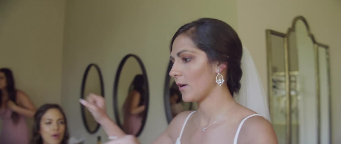 A bride sings and dances in a dressing room