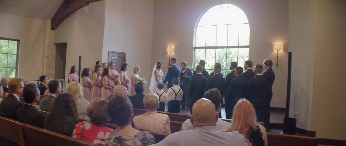 A bride and groom are married in front of wedding guests