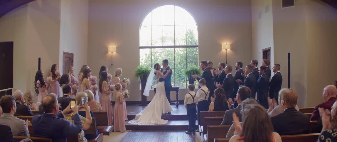 A bride and groom kiss at their wedding ceremony