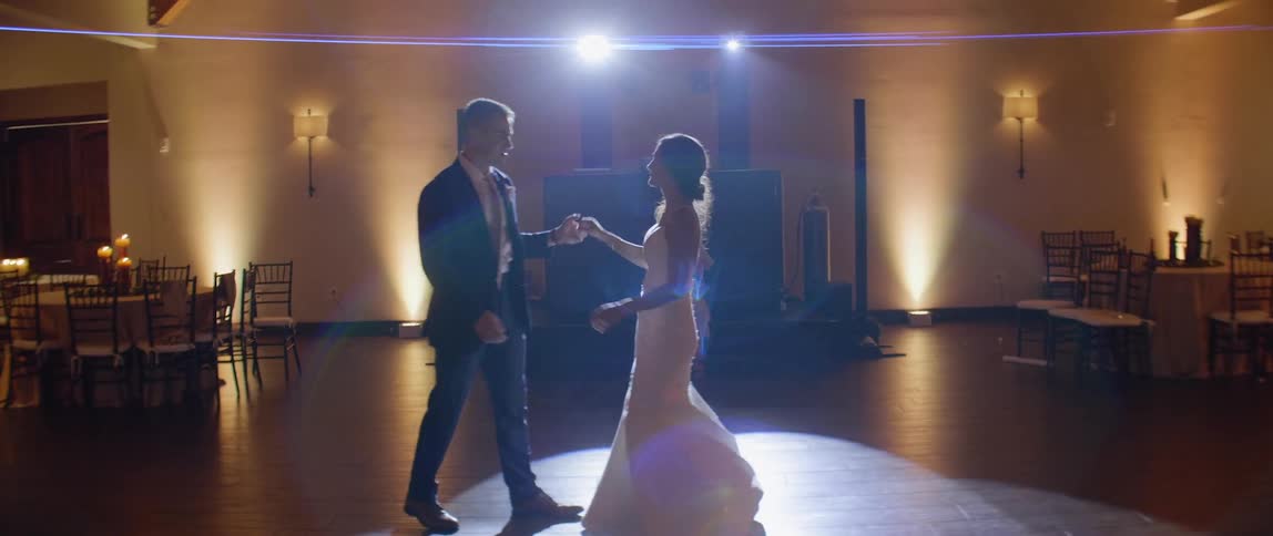 Bride and groom dance at reception while being photographed