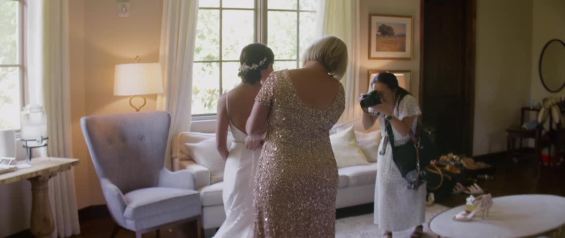Bride in living room being photographed