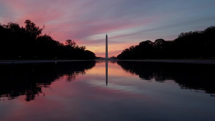Water ripples in front of the washington monument at sunset