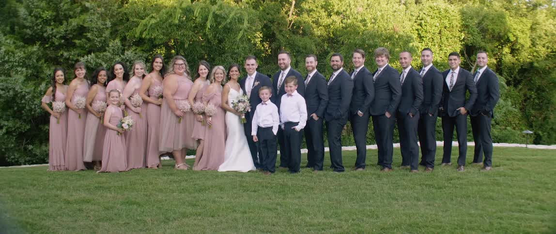 Wedding party stands for a formal photograph