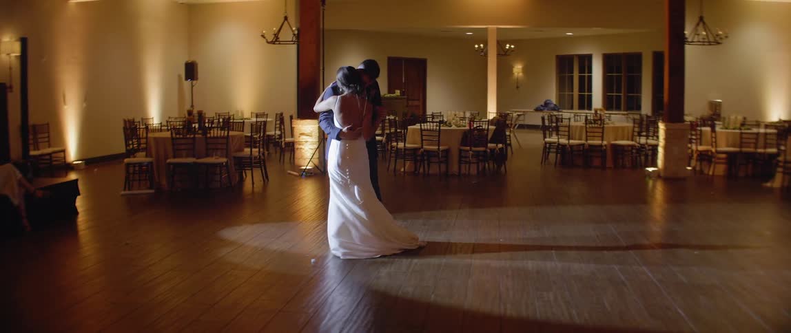 A bride and groom dance at their reception