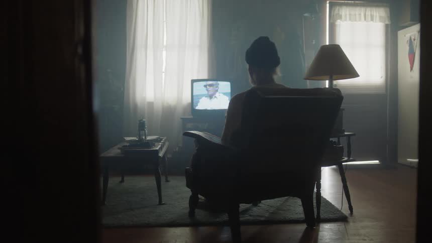 A person is sitting in the chair watching tv
