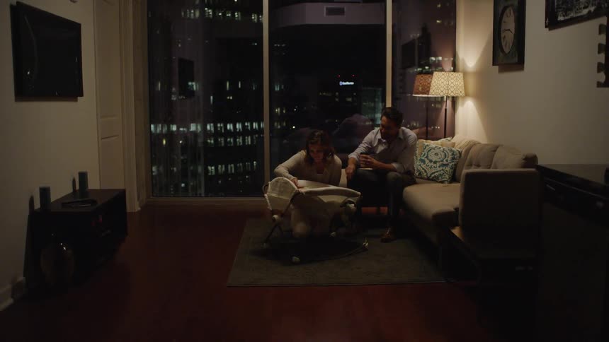 Parents Taking Care Of Baby In High Rise Apartment