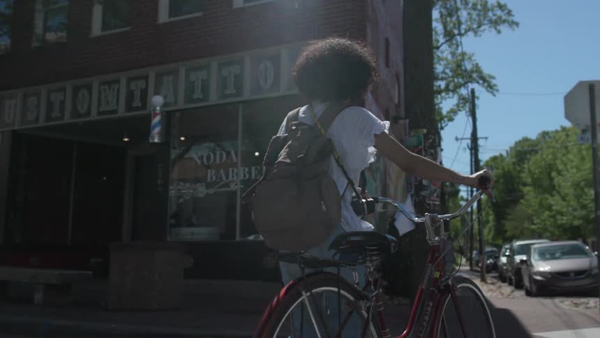 Child walks bike across the street