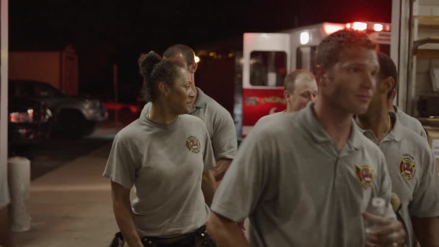 A group of firefighters enter the fire house
