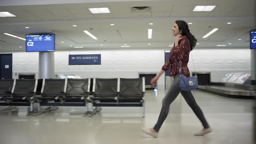 A man and woman embrace in the airport