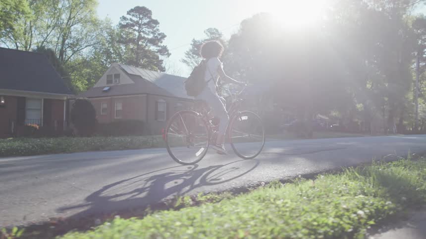 Woman rides a bicycle on a sunny day