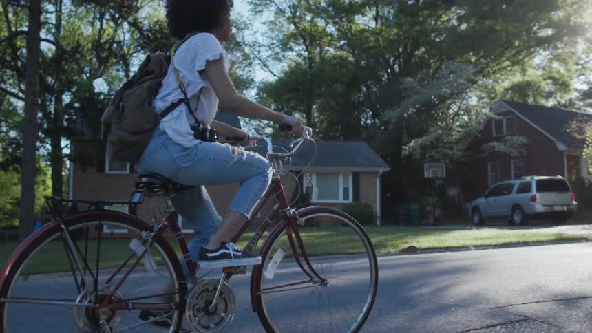 A child rides their bicycle on a sunny day