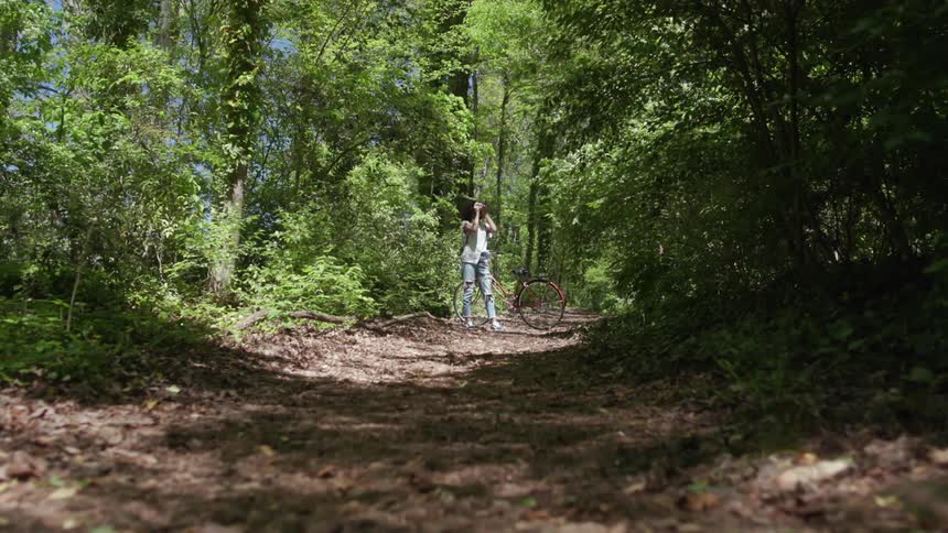 A woman takes photos in the woods