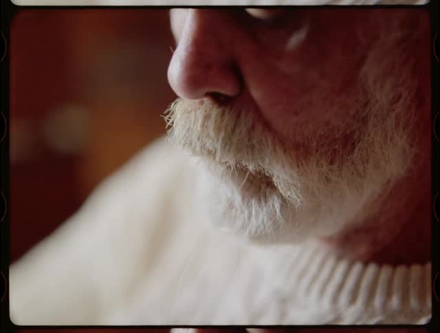 A man puts a fishing line in his mouth