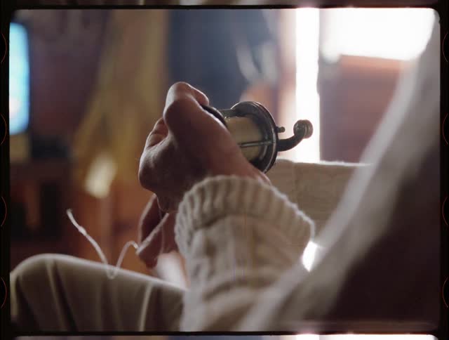 A man pulls on a fishing line at home