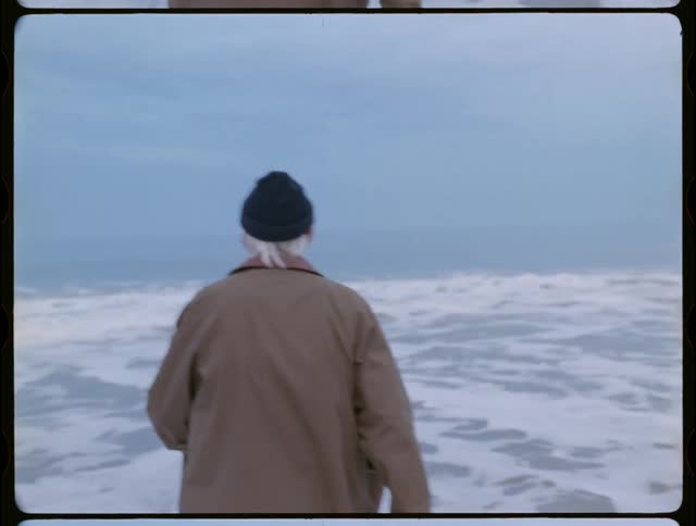 Older man is walking out into the ocean