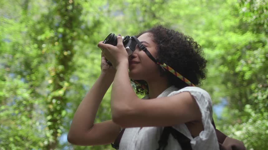 Woman taking pictures in the woods